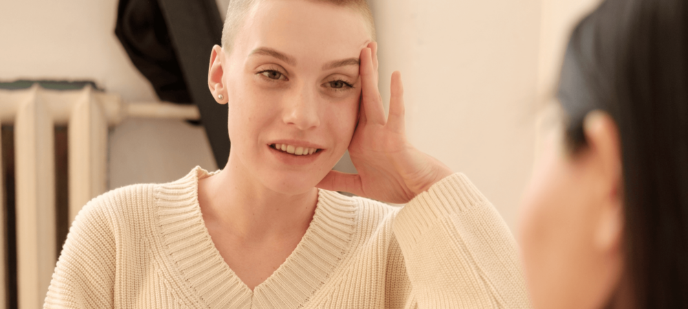 A young woman talking to a support worker at home
